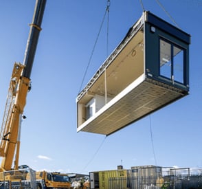 modular building being lifted by a crane